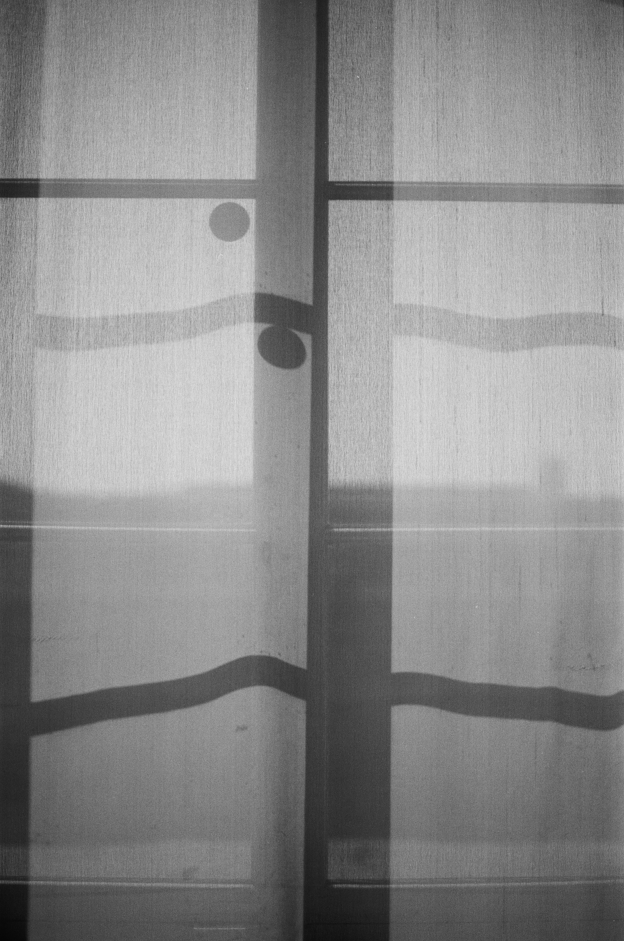Shadows on a sheer curtain