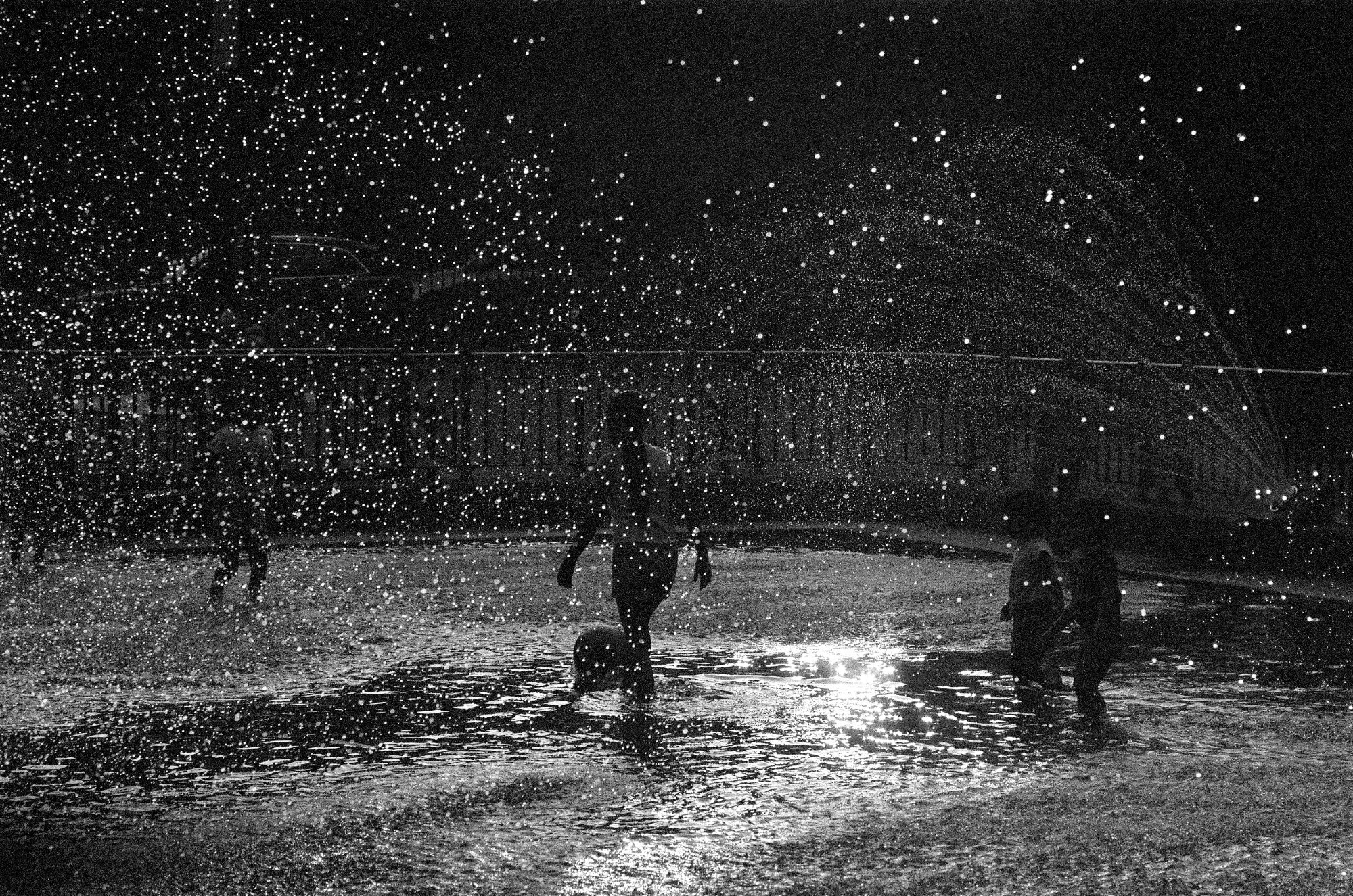 Children playing in fountain spray